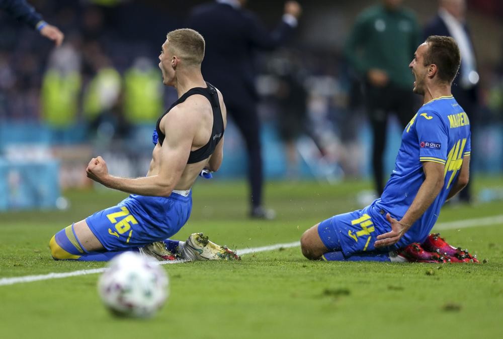 Ukraine's Artem Dovbyk, left, reacts after scoring his team's winning goal during the Euro 2020 soccer championship round of 16 match between Sweden and Ukraine at Hampden Park in Glasgow, Scotland, Tuesday, June 29, 2021. (Robert Perry/Pool Photo via AP)